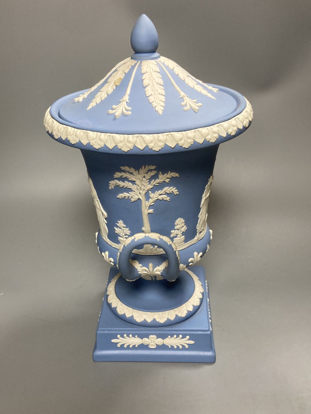 A 20th century Wedgwood light blue jasperware two-handled campagna-shaped urn and cover,
